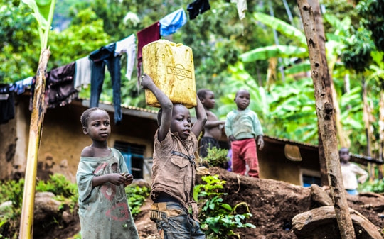 Children doing chores in a garden in Uganda