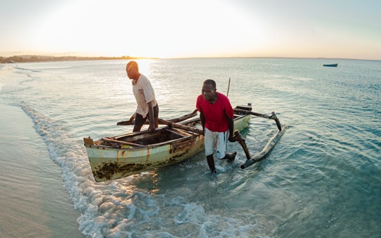 Two men with a boat on the beach