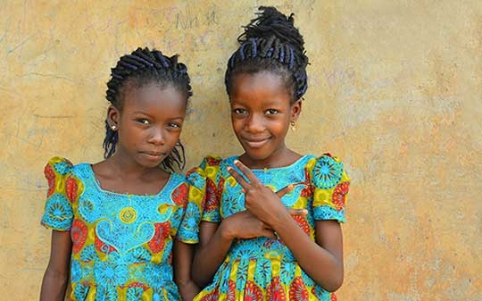 Nigerian girls against a beige wall