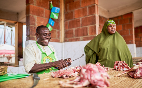 man and woman at a meat shop