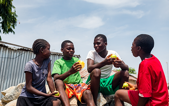 children playing and eating fruit