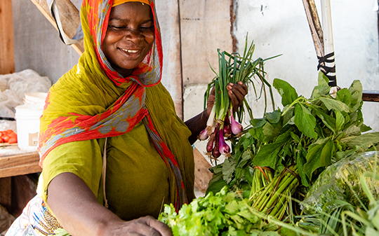 a vendor sorting vegetables at her stall