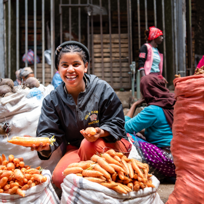 women with bags of carrots