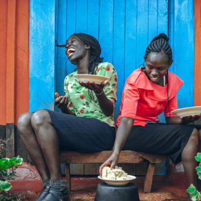 two womens eating and laughing together