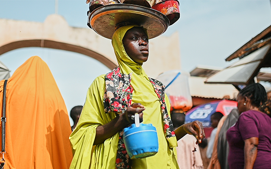 a woman carrying her water can